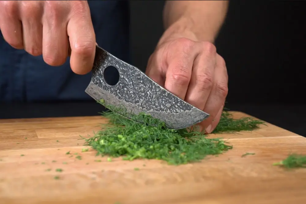 Mincing herbs with the hand-forged knife