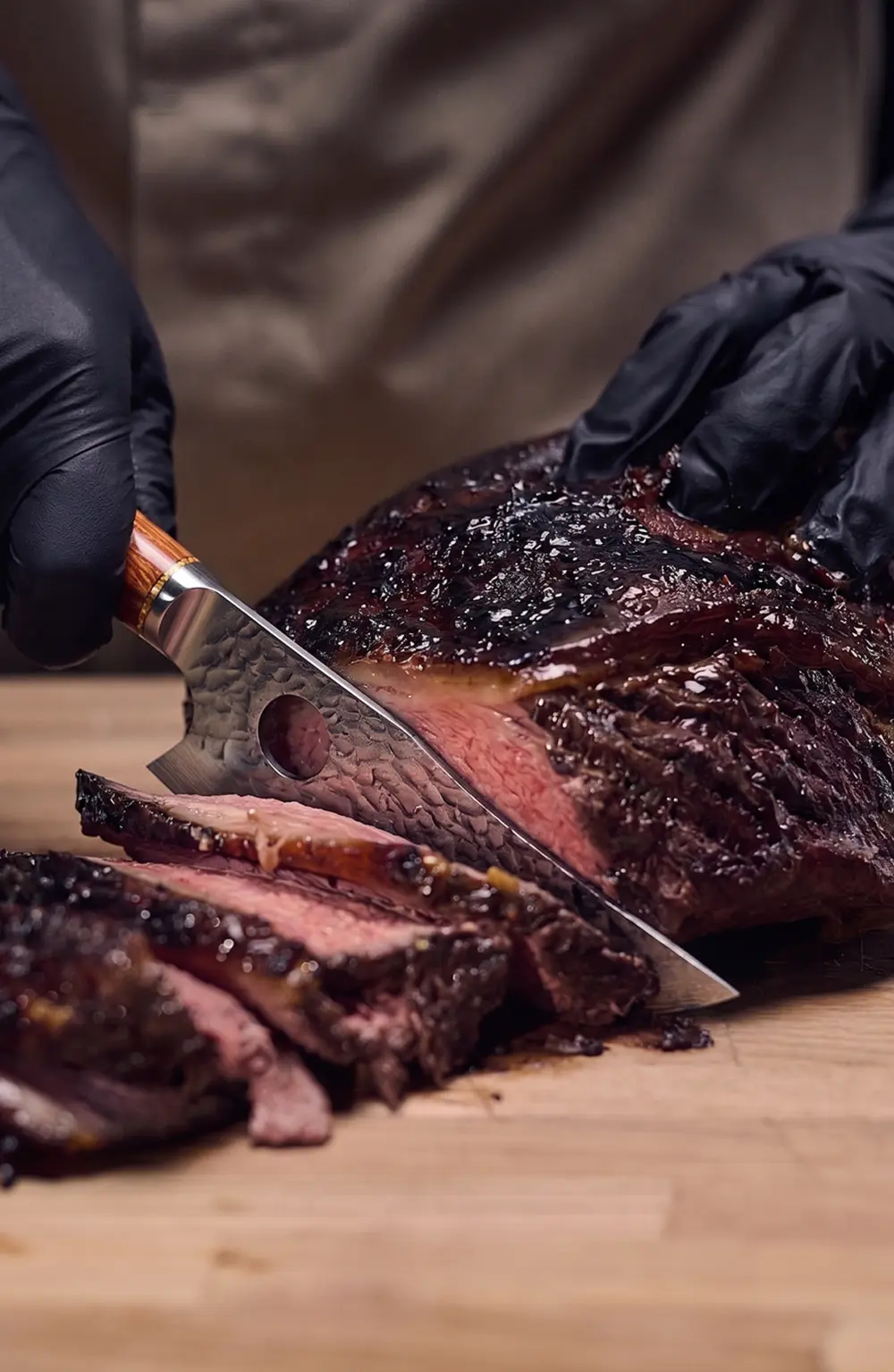 Slicing meat cleanly with the hand-forged knife